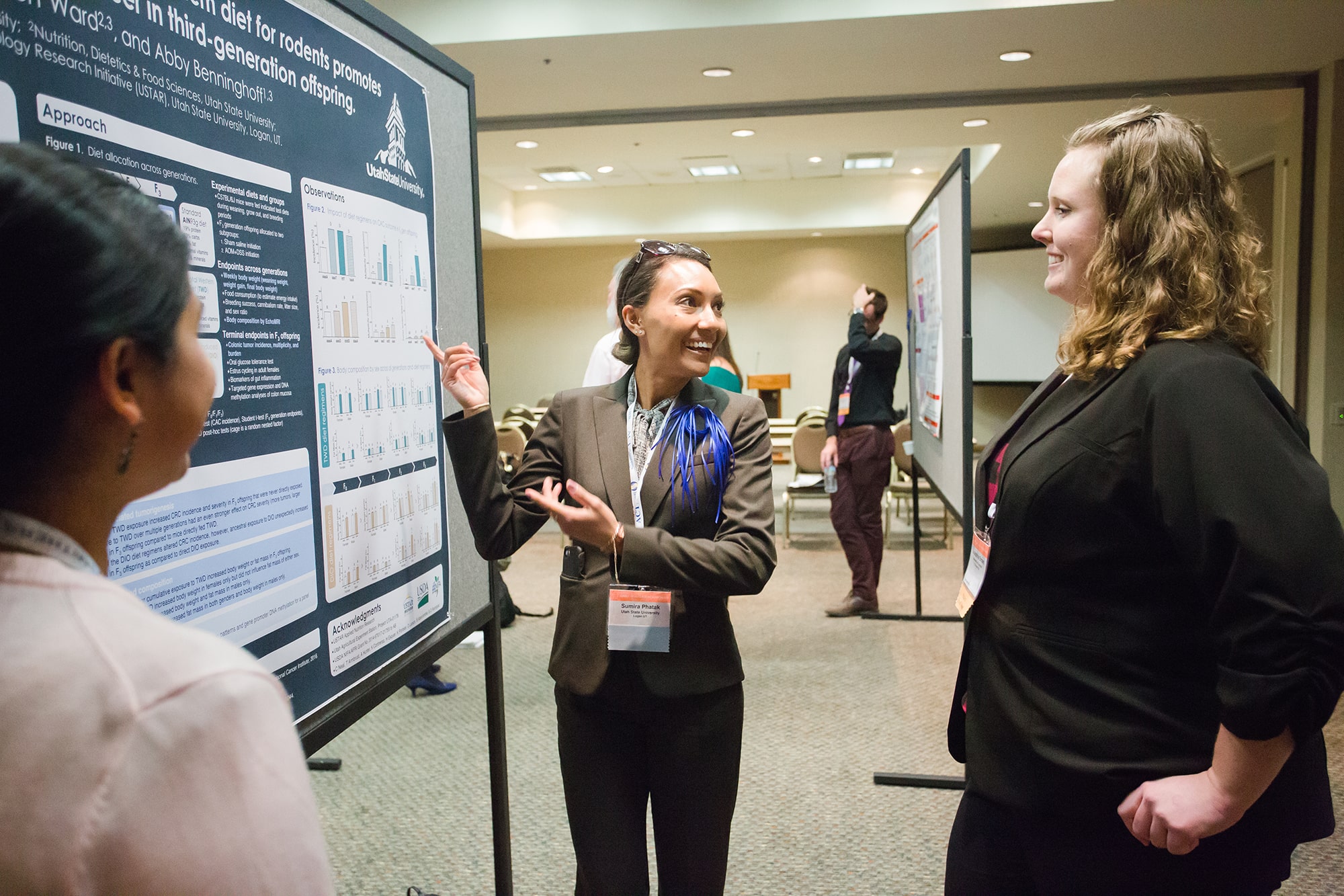 3 people looking at a poster