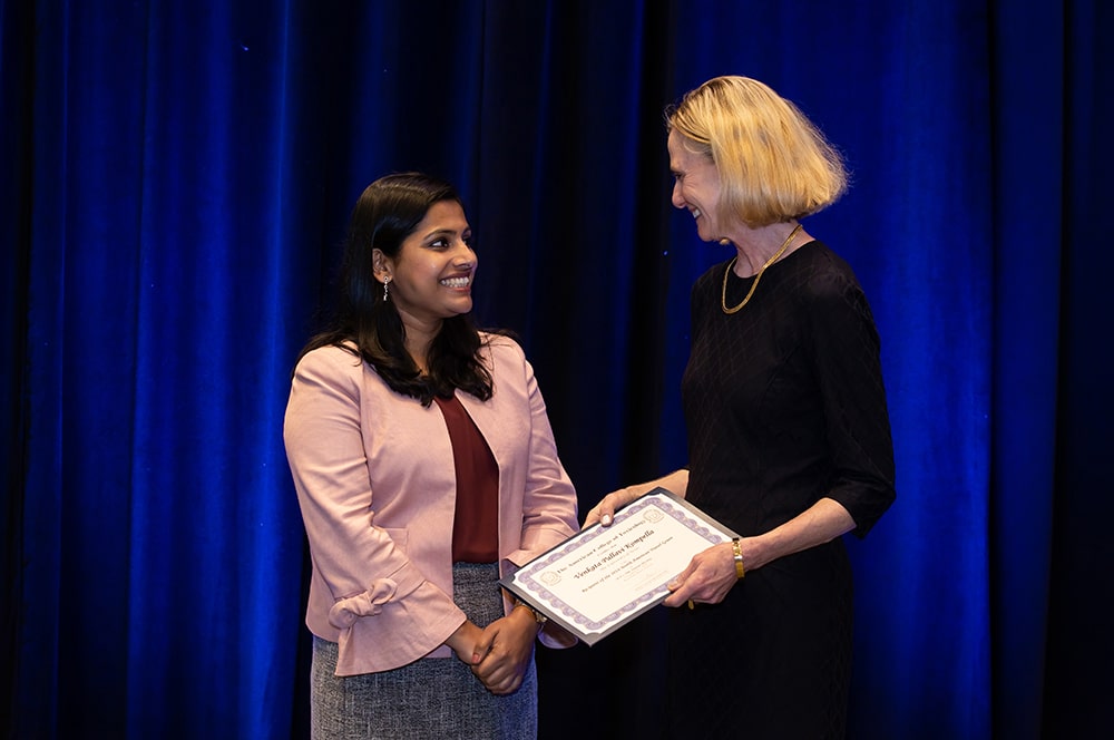 Awardee revieving a plaque