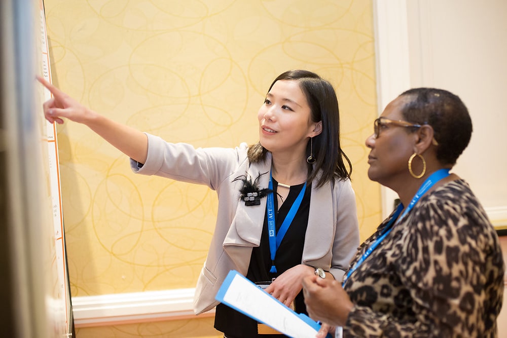 2 Attendee looking at a poster